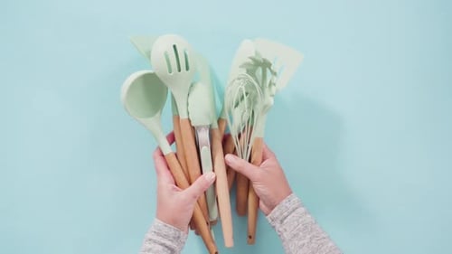 Mint Green Kitchen Utensils Arranged on Pastel Background