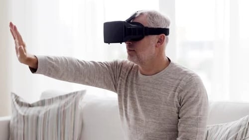 Man using virtual reality headset on a sofa