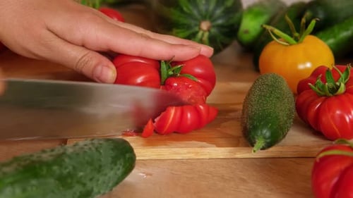 Slicing Fresh Tomatoes with a Knife in Kitchen