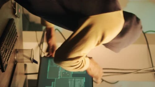 Hacker Coding at Computer in Dark Room