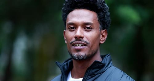 Man Smiling Outdoors in Close Up Portrait