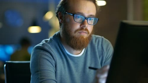Talented Young Concept Artist Drawing on a Digital Pen Display Tablet While Sitting at His Working
