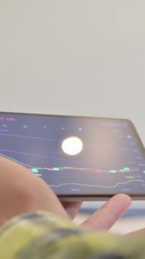 Close up of African Man Trading on Horizontal Smartphone, Financial Graph, Vertical Video
