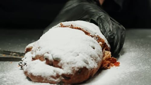 German Stollen Bakery Dessert Closeup Bun with Spices Raisins Nuts and Candied Fruits and Powdered