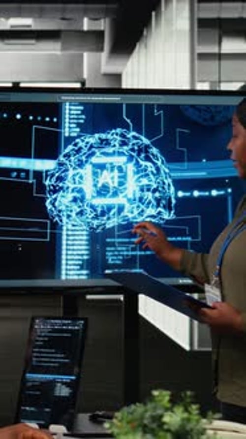 Woman Explaining AI Brain Graphic on Screen at Work