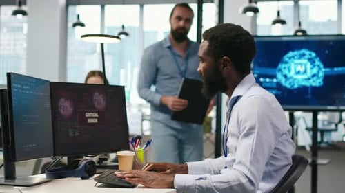 Programmer in Office Requesting Help From Coworkers to Fix Critical Error