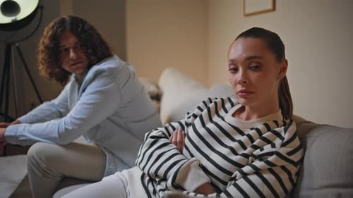 Upset Couple After Argument on Sofa