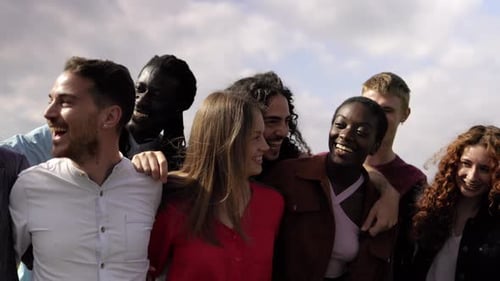 Happy multiracial group of friends having fun hugging outdoor