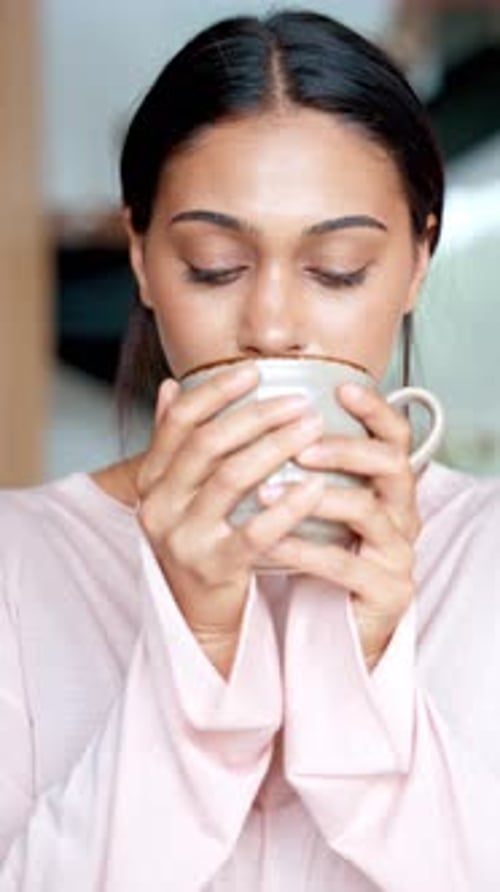 Woman in Pink Shirt Drinks From Mug