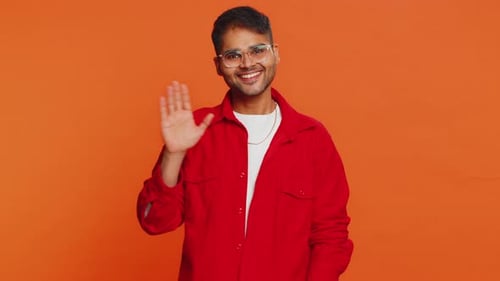 Young Adult Smiling and Waving Hello