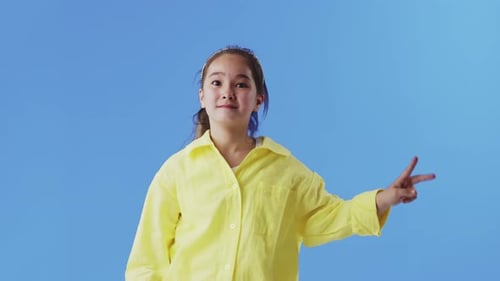 Happy Girl Gesturing on Blue Background