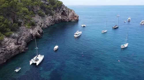 Boats moored in crystal clear waters in the waters of Majorca, Balearic Islands