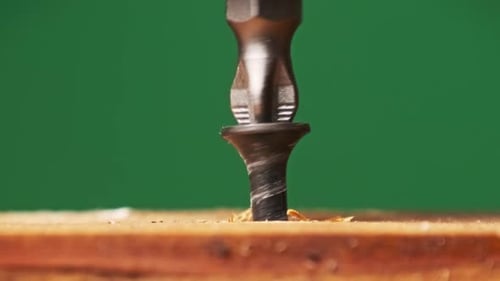 Unscrew Screw From a Wooden Board with a Screwdriver ClosePp