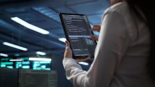 Close Up of Woman Doing Maintenance in Server Room Using Tablet