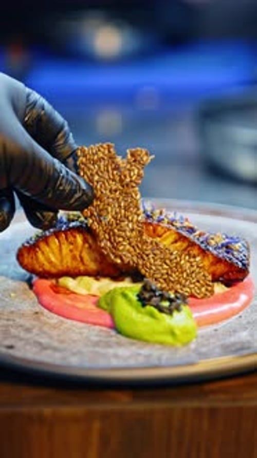 Chef Plates Salmon Fillet With Artistic Garnishes