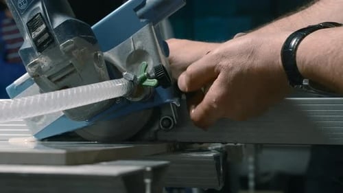 Construction Worker Cutting Tile with an Industrial Wet Saw