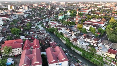 Aerial view of housing in Yogyakarta city at sunset with view of Mount Merapi, Indonesia.