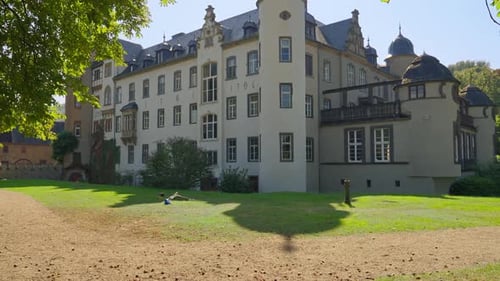 Tilting upwards towards the Namedy Castle built in 1701 near the banks of the Rhine River, Germany