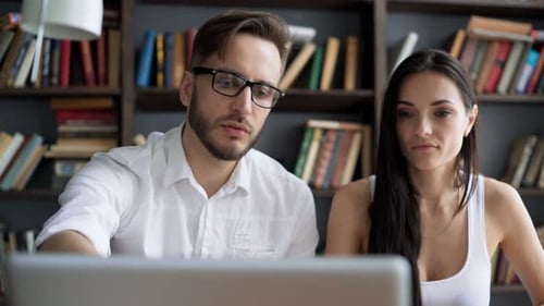 Two Students Brainstorm Work by Discuss with Desktop in Trendy Loft Close
