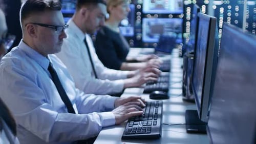 Focused Professionals Working on Computers in Modern Office