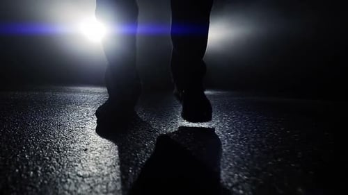 One Person Walking Alone on Street in Dark Night