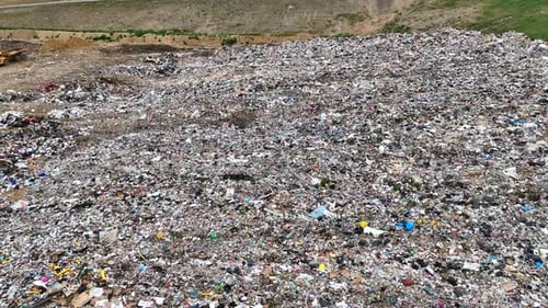 Aerial Drone Flyover of landfill with filled trash