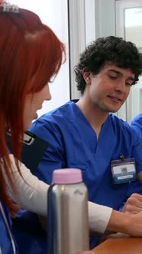 Medical team collaborating with technology in hospital cafeteria