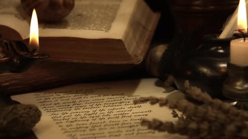 Candlelit Book and Script on a Table