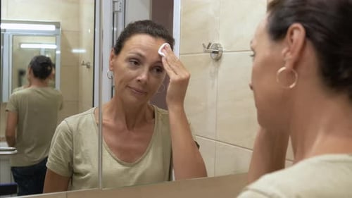 A Woman Cleans Her Face
