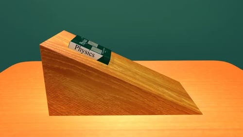 Physics book rests upon a wooden inclined plane experiment