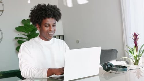 Young Adult Working on Laptop at Home