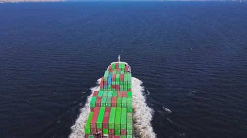 Cargo Container Ship with Truck Size Containers Cruising in Sea