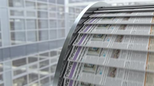 Close Up View to Conveyor Belt with Fresh Newspapers with Printed Latest News