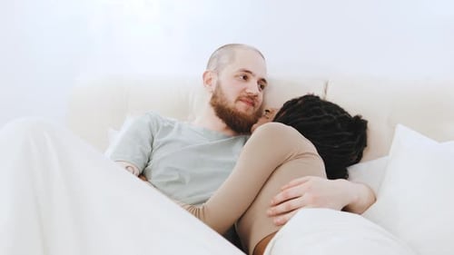 Intimate Couple Cuddling Together in Bed