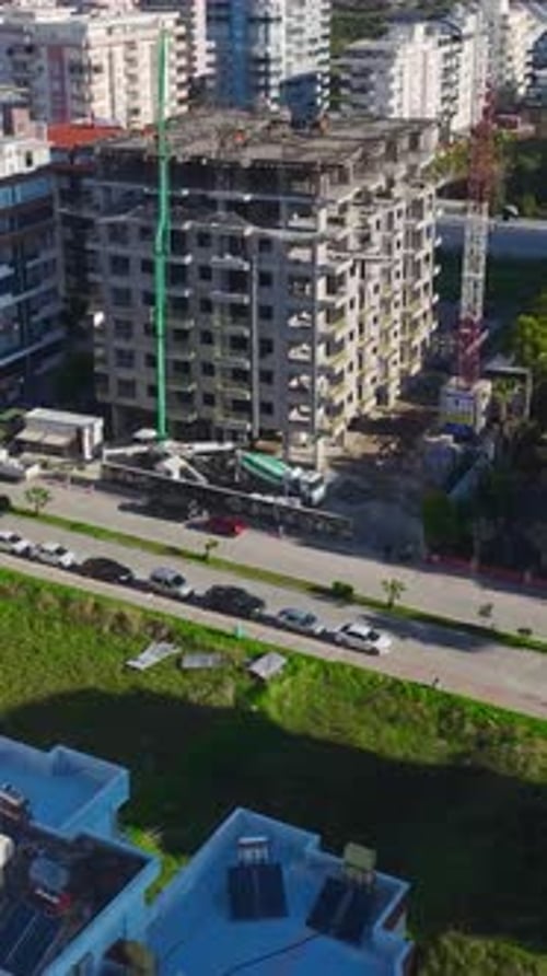 Vertical Video of Builders Working on a New House Setting Up Metal Supports and Preparing for the
