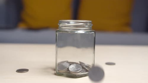 Slow motion of coin falling to moneybox with bounce. Cash investment and savings for retirement. Exc