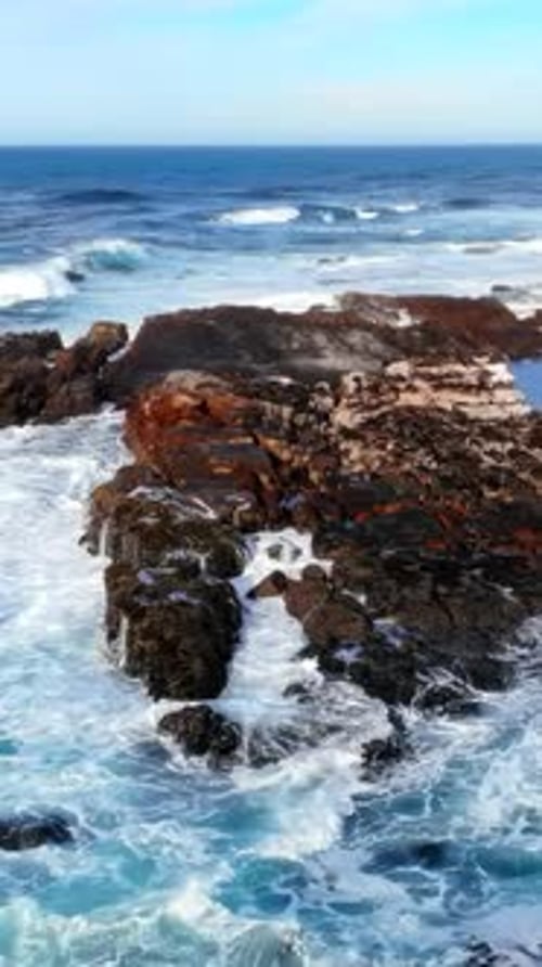 Violent Waves Crash Against Cliffs Wild Surf Pounds Rugged Coast Beneath Vigilant Lookout Tower