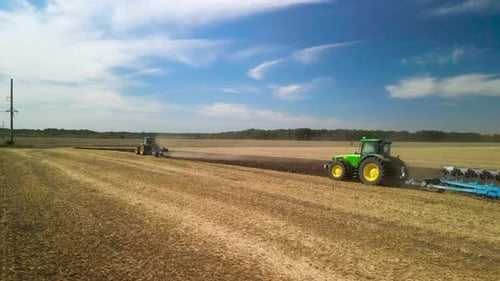 Tractors plowing the field in Ukraine