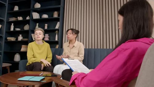 Couple Engaged in Therapy Session With Counselor