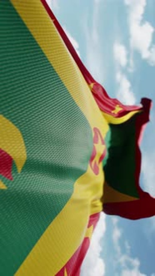 Waving Grenada Flag Animation Against Blue Sky