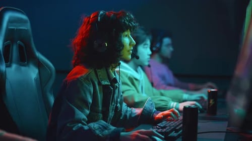 Young Biracial Woman with Energy Drink Playing Game at Cyberclub