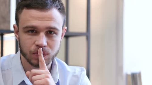 Silence Please Finger on Lips of Young Man