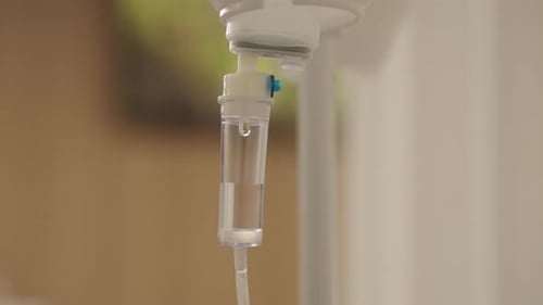 Intravenous Drip Fluid Flowing in Hospital Room