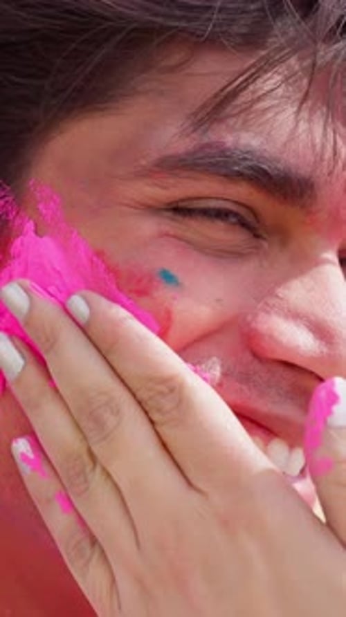 Man Smiling with Colorful Powder on His Face