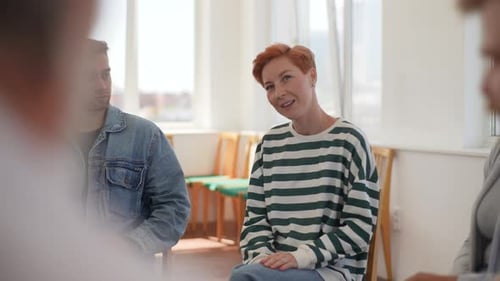 Tracking Shot of Young Caucasian Woman Sharing Problem Sitting in Circle During Group Therapy