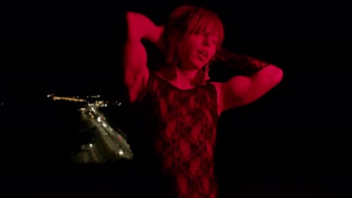 Sensual Woman Posing Under Red Light at Night