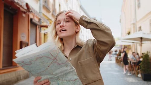 Woman Looking at Map on City Street