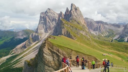 Tourists Stand on Viewpoint Over Valley Looking at Mountain