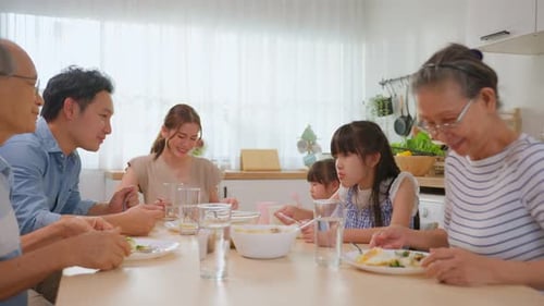 Happy Multi-Generational Family Enjoying Meal at Home