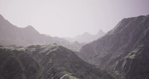 Dramatic Mountain Range Features Rugged Peaks and Rolling Hills